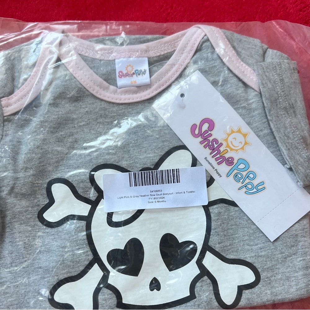 Brand new skull printed onsie.
